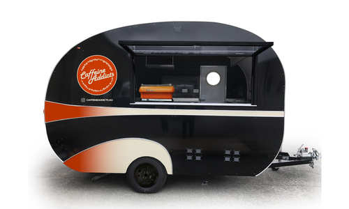Caffeine Addiction coffee trailer with black and orange wrap design.