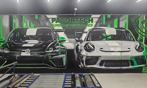 Pacortech mural showcasing Porsche and VW cars with green neon accents.