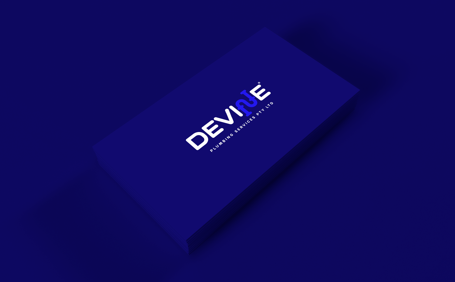 Devine Plumbing business card design in blue, highlighting professional and memorable branding.