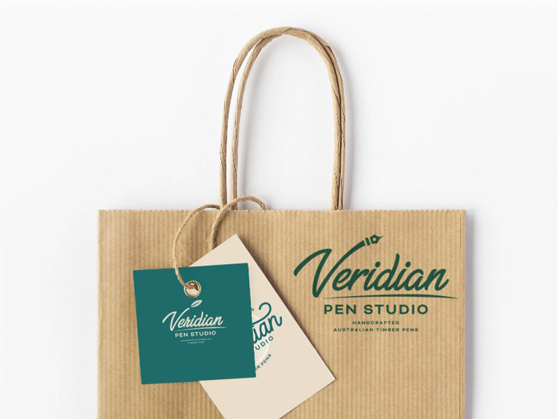 Eco-friendly brown kraft bag featuring the Veridian Pen Studio logo, showcasing sustainable and aesthetic product packaging design.
