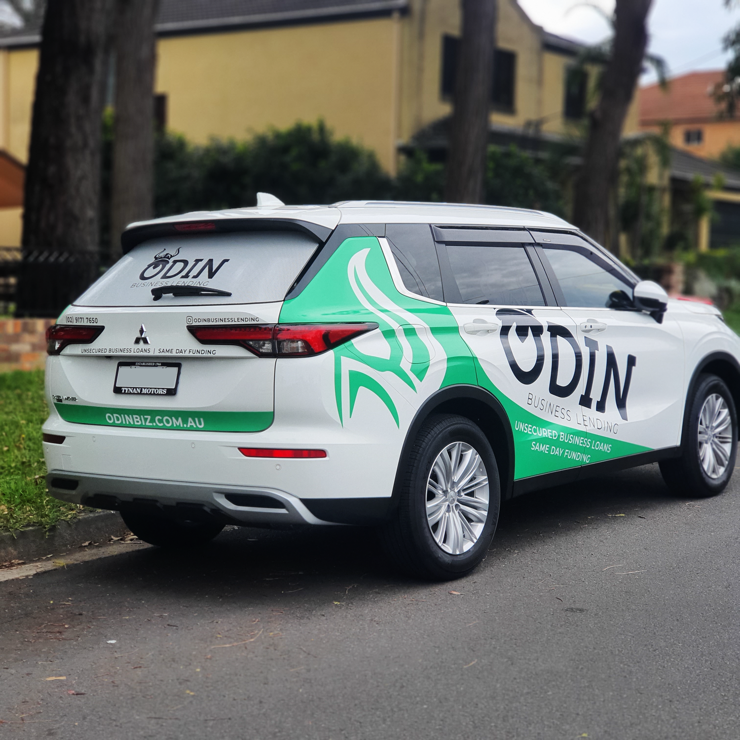 Mitsubishi SUV with a custom corporate livery for ODIN Business Lending, showcasing a professional and eye-catching vehicle wrap design from Tiana Kaiserfeld Corporate Livery Portfolio.