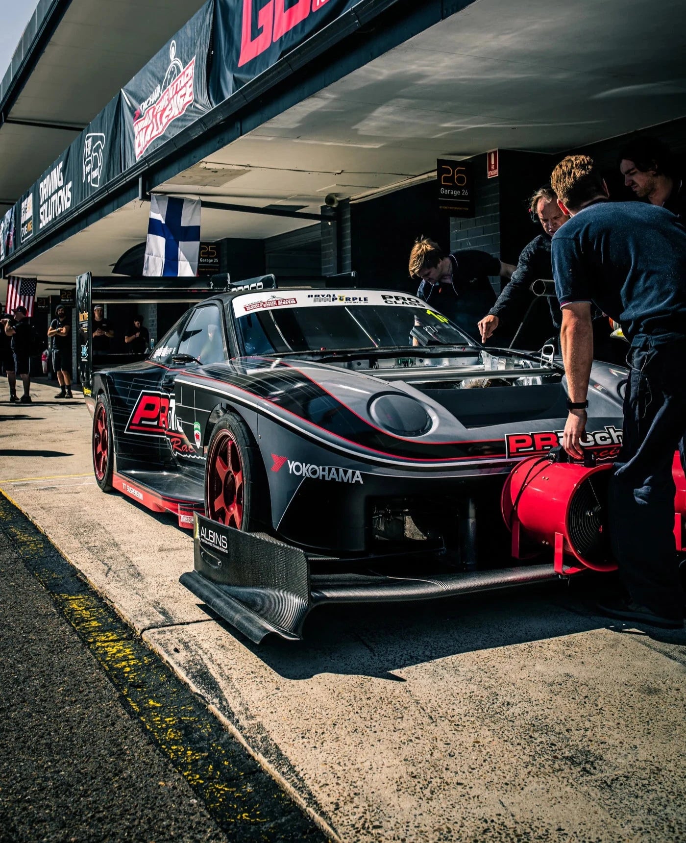 Custom-designed livery on a Porsche RP968 race car in the pit lane, highlighting the bold and creative livery work in the Motorsport Livery Portfolio by Tiana Semrany.